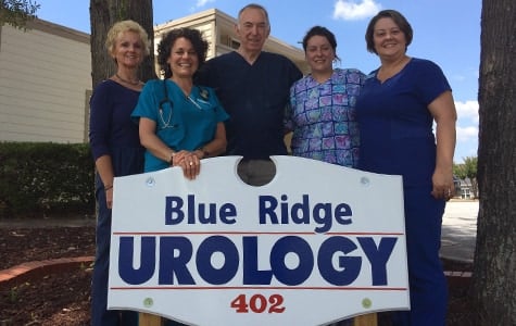 Dr. Walton and four members of the Blue Ridge Urology staff standing behind the office's sign at 402 Memorial Drive